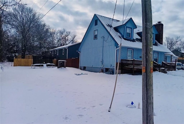 view of snow covered rear of property