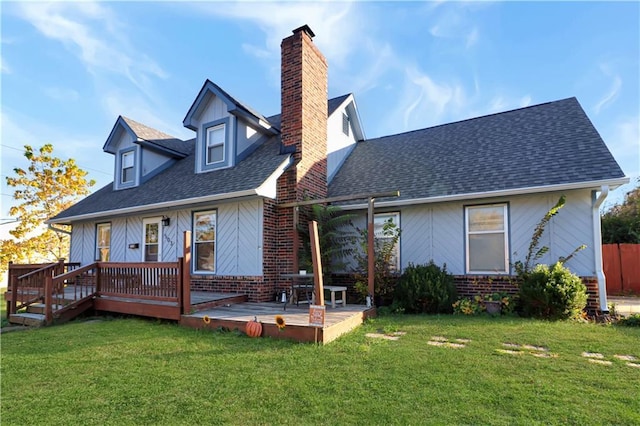 rear view of property featuring a yard and a deck