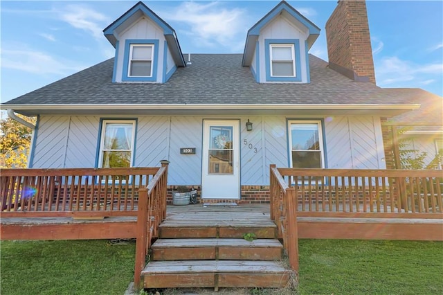 cape cod-style house with a front lawn