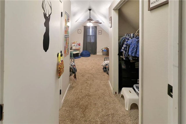 walk in closet featuring lofted ceiling, carpet, and ceiling fan