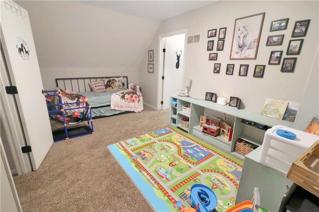 bedroom with vaulted ceiling and carpet floors