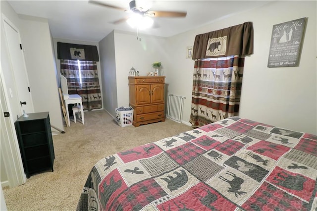 bedroom featuring ceiling fan and light carpet