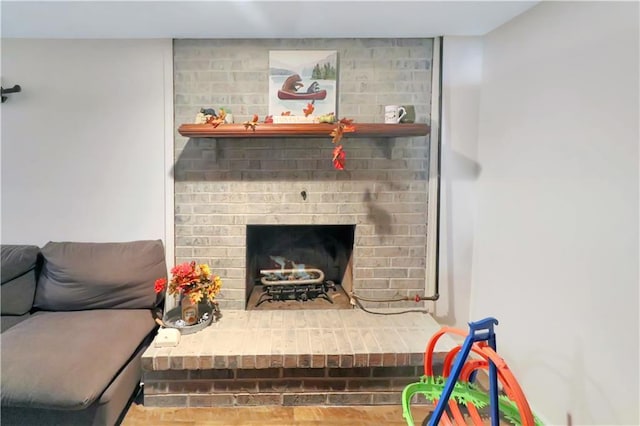 living room with a brick fireplace