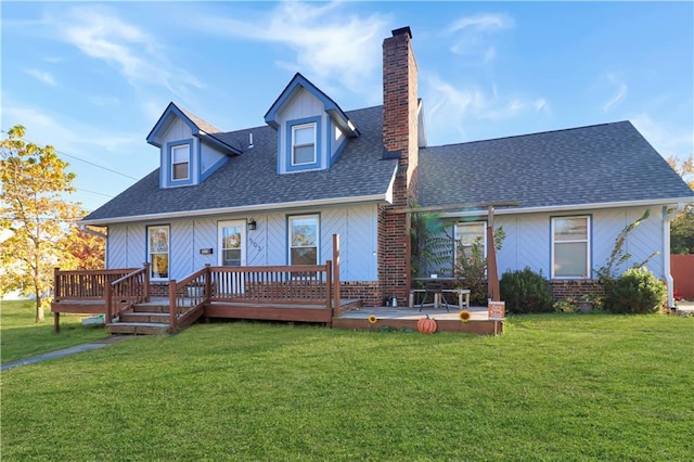 view of front of home with a deck and a front yard