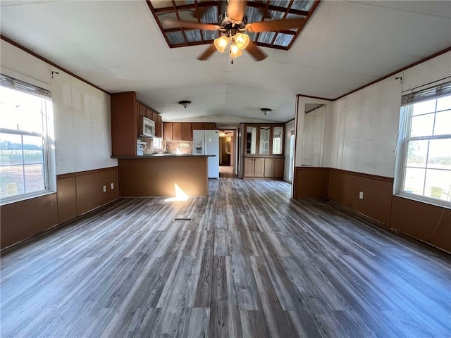 unfurnished living room featuring lofted ceiling, dark hardwood / wood-style floors, and ceiling fan