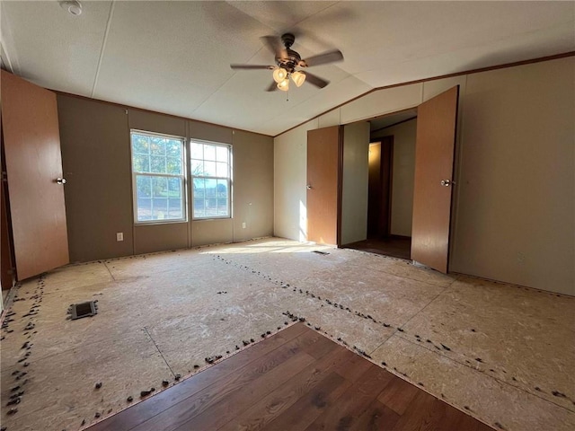 unfurnished room featuring ceiling fan, hardwood / wood-style flooring, and vaulted ceiling