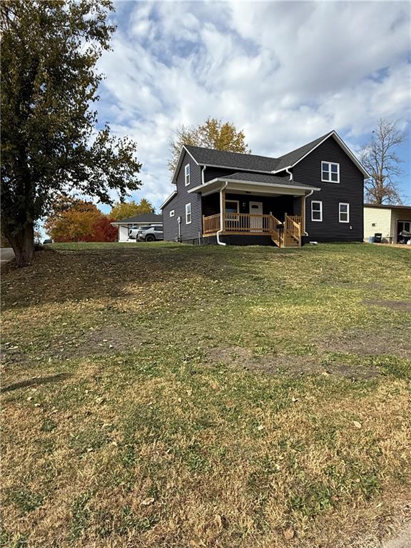 exterior space featuring a yard and covered porch