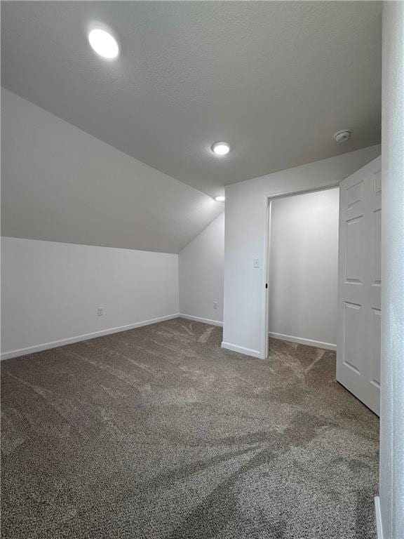 bonus room with lofted ceiling and carpet floors