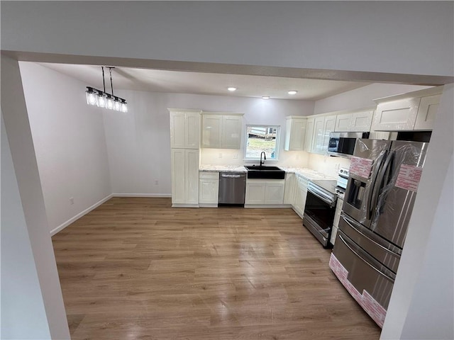 kitchen with white cabinets, stainless steel appliances, and sink