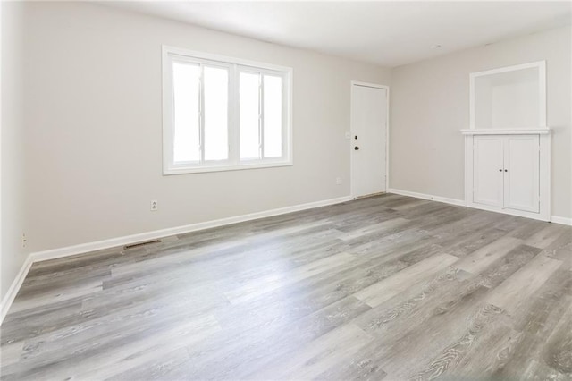 unfurnished room featuring light wood-type flooring