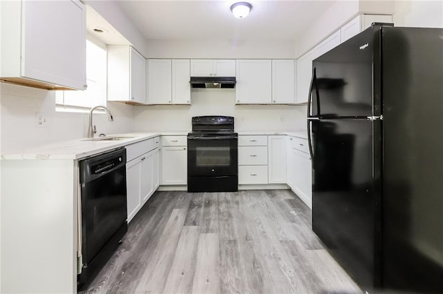 kitchen featuring black appliances, sink, light wood-type flooring, and white cabinets