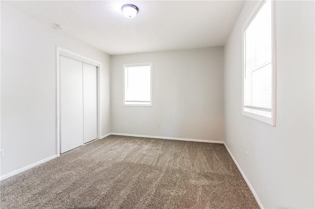 unfurnished bedroom featuring a closet and carpet