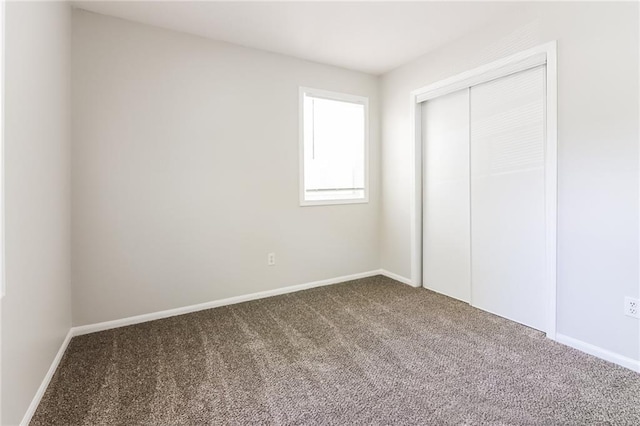 unfurnished bedroom featuring a closet and carpet