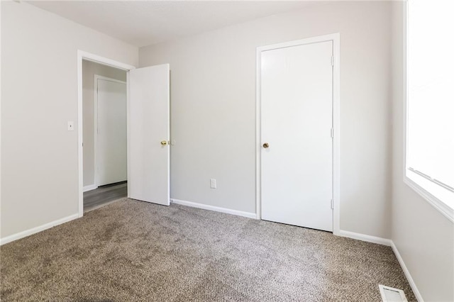 unfurnished bedroom with carpet floors