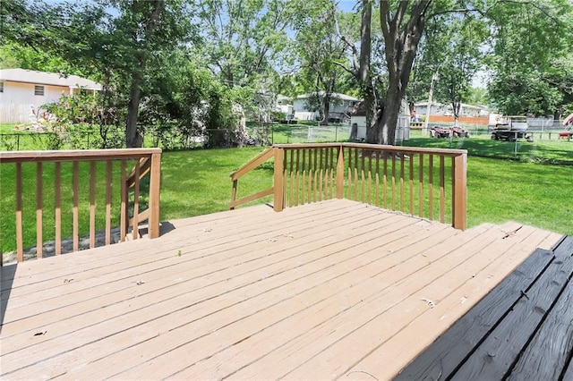 wooden deck featuring a yard