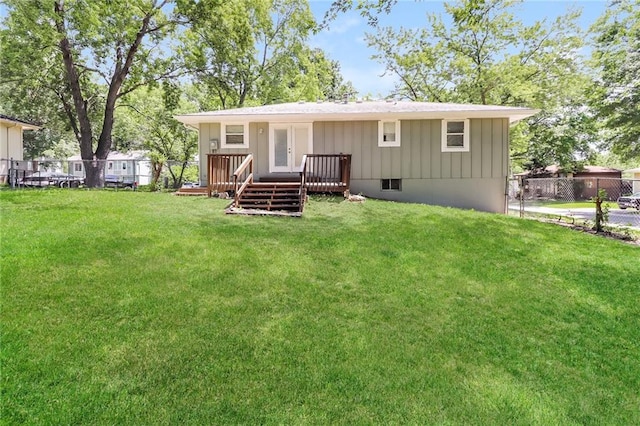 rear view of property with a lawn