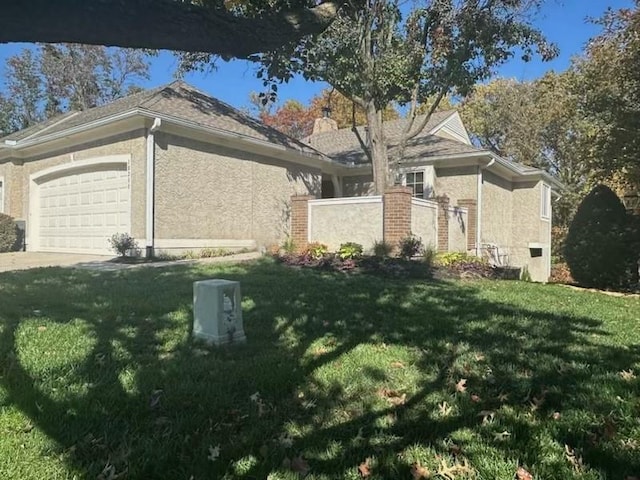 view of side of home with a yard and a garage