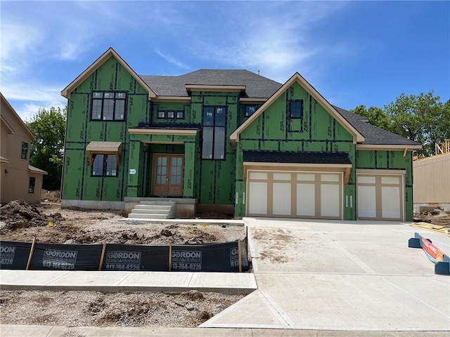 16904 Parkhill St, Overland Park, KS 66221 - property in mid-construction featuring french doors, concrete driveway, a garage, and a shingled roof