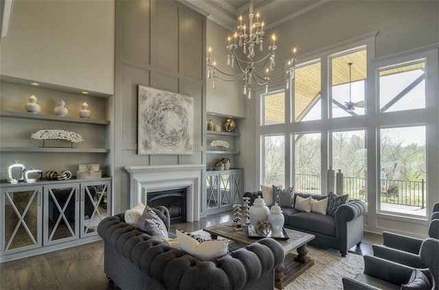 16904 Parkhill St, Overland Park, KS 66221 - living room with a high ceiling, plenty of natural light, built in features, crown molding, and wood finished floors