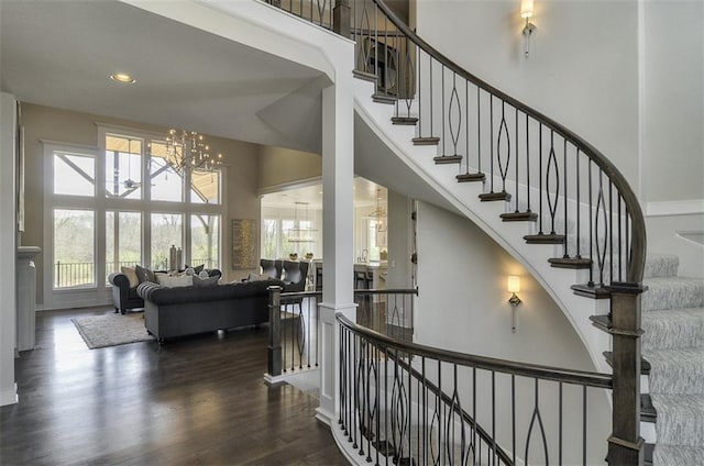 16904 Parkhill St, Overland Park, KS 66221 - stairs with a high ceiling, a chandelier, wood finished floors, and recessed lighting