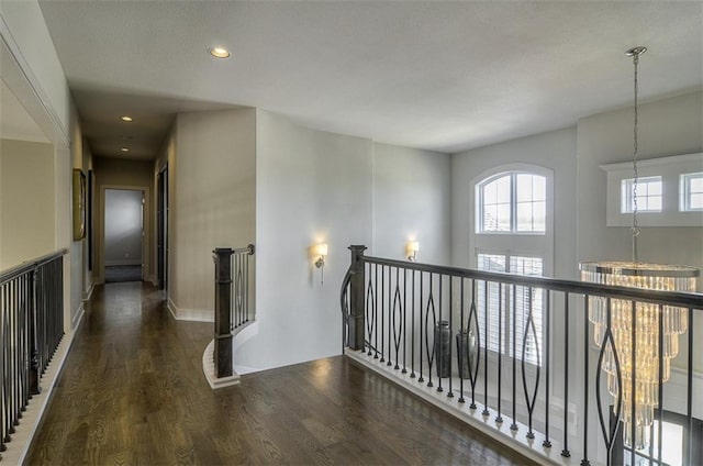 16904 Parkhill St, Overland Park, KS 66221 - hallway featuring wood finished floors, recessed lighting, and an upstairs landing