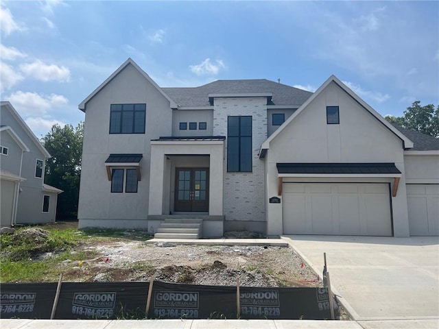 16904 Parkhill St, Overland Park, KS 66221 - view of front of house featuring french doors, stucco siding, a standing seam roof, and concrete driveway