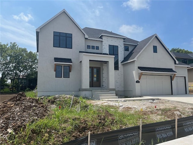 16904 Parkhill St, Overland Park, KS 66221 - view of front facade featuring driveway, a standing seam roof, and brick siding