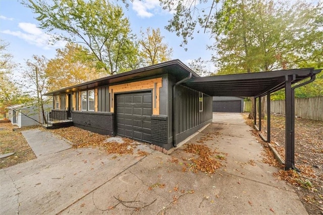 view of side of property with a carport and a garage