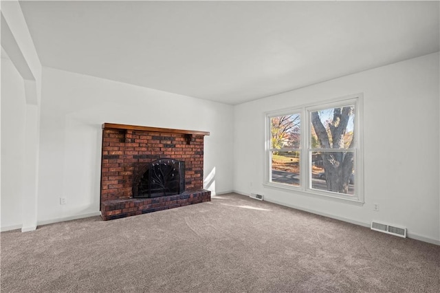 unfurnished living room with carpet flooring and a fireplace