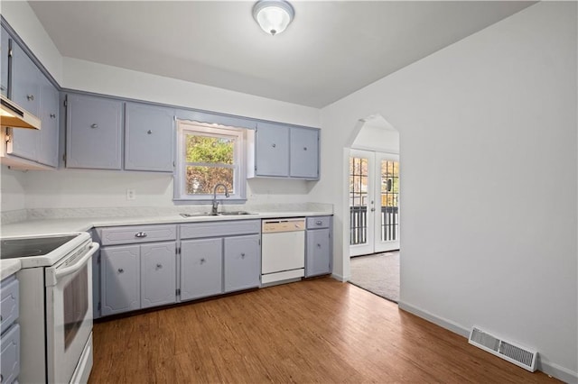 kitchen featuring french doors, sink, light hardwood / wood-style flooring, white appliances, and gray cabinets