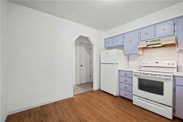 kitchen featuring light wood-type flooring and white appliances