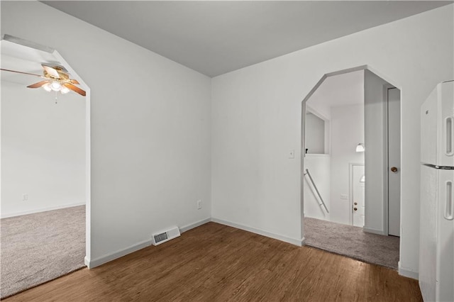 empty room featuring ceiling fan and wood-type flooring