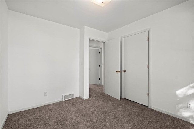 unfurnished bedroom featuring carpet and a closet