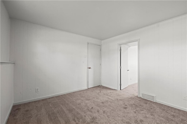 spare room with light colored carpet