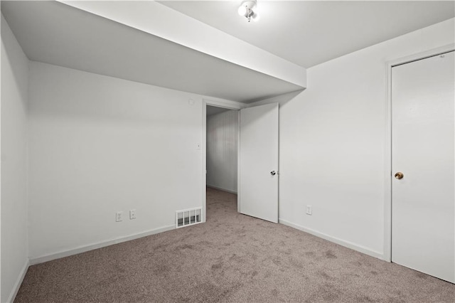 basement featuring light colored carpet