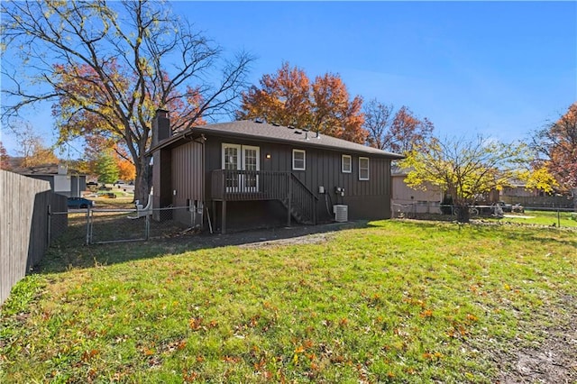 rear view of house with a yard