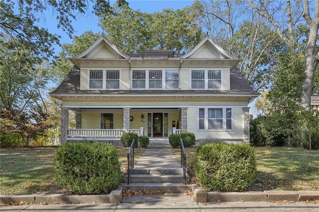 view of front of property with a front lawn and covered porch