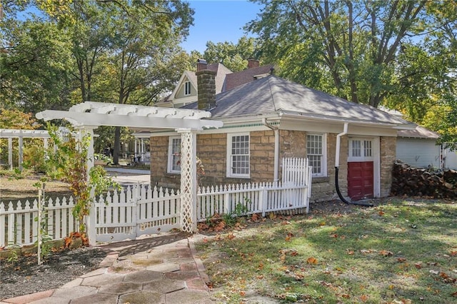 503 S 2nd St, Clinton, MO 64735 - view of front of property featuring stone siding, a chimney, and a shingled roof