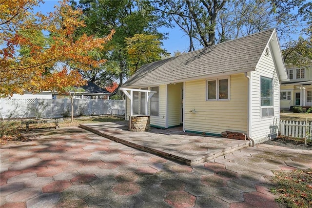 503 S 2nd St, Clinton, MO 64735 - back of house with a patio area, roof with shingles, and a fenced backyard