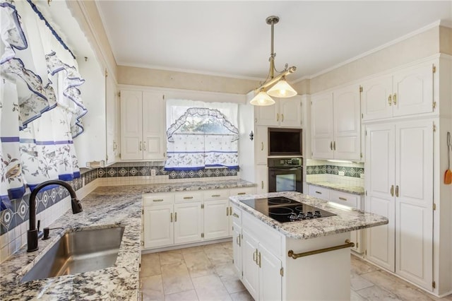 kitchen featuring tasteful backsplash, black appliances, sink, white cabinetry, and a kitchen island