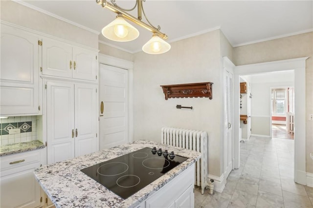 503 S 2nd St, Clinton, MO 64735 - kitchen featuring radiator, black electric cooktop, light marble finish flooring, white cabinetry, and ornamental molding