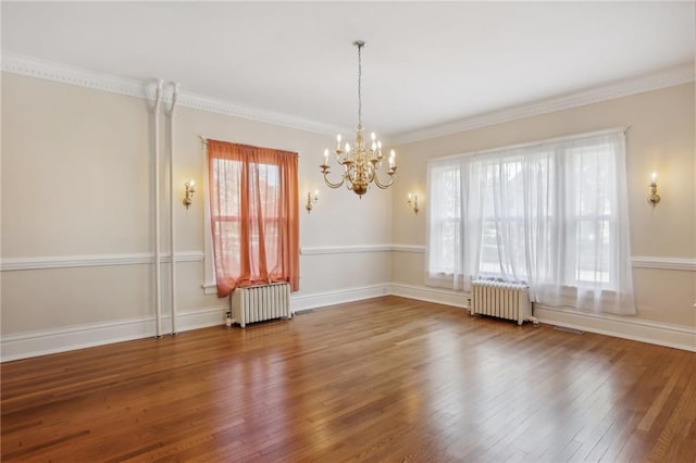 unfurnished room with crown molding, radiator heating unit, an inviting chandelier, and hardwood / wood-style flooring