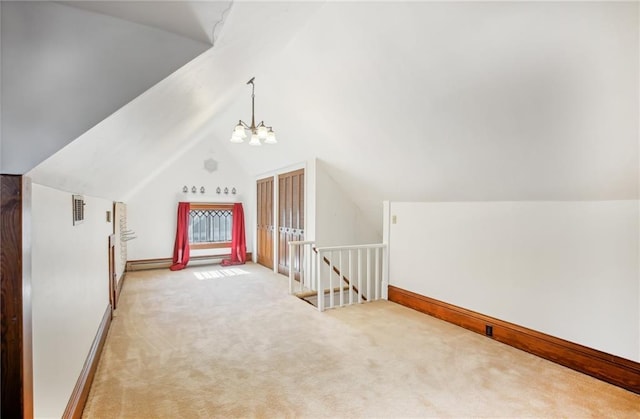 bonus room with light carpet, a chandelier, and lofted ceiling