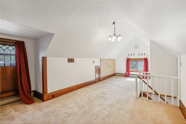 additional living space featuring carpet, lofted ceiling, and a notable chandelier