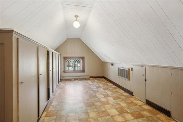 bonus room featuring wood walls, a baseboard radiator, and lofted ceiling