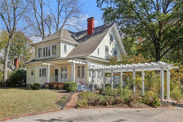 503 S 2nd St, Clinton, MO 64735 - view of front of property with a pergola, a porch, a chimney, a shingled roof, and a front lawn