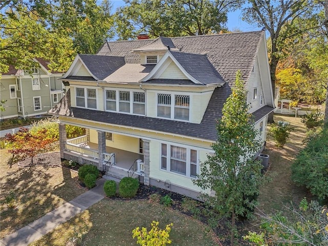 503 S 2nd St, Clinton, MO 64735 - view of front facade with covered porch, a shingled roof, central AC unit, and a chimney