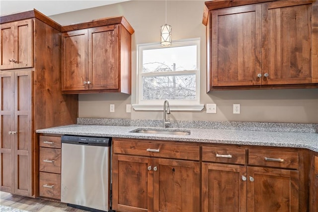 kitchen with dishwasher, sink, pendant lighting, and light stone counters