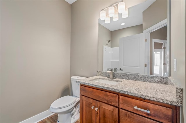 bathroom with walk in shower, vanity, toilet, and wood-type flooring