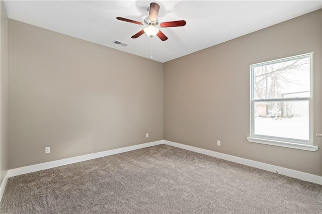 carpeted spare room with ceiling fan